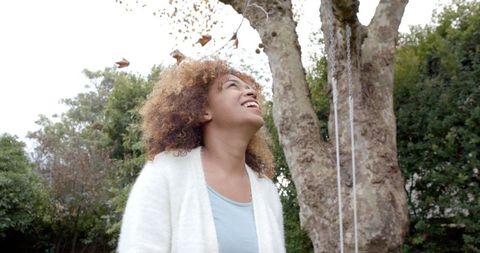 Smiling Woman Enjoying Autumn in Garden