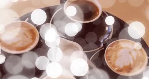 Rotating Tray of Coffee Cups and Milk Pitcher with Bokeh Lighting Highlighting Cafe Service