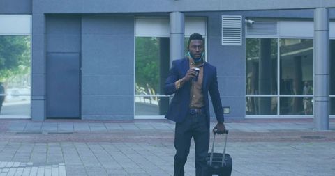 Business Traveler Walking with Coffee in Urban Plaza