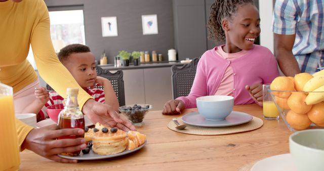 Family Enjoying Breakfast Together at Home Table with Pancakes and Fresh Fruits - Download Free Stock Images Pikwizard.com