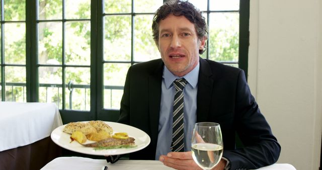 Businessman Enjoying Gourmet Meal at Restaurant - Download Free Stock Images Pikwizard.com