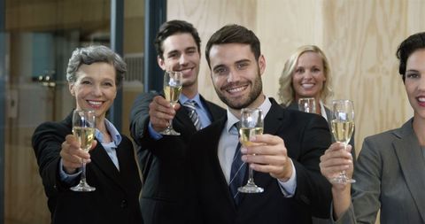 Business professionals toasting to success with champagne