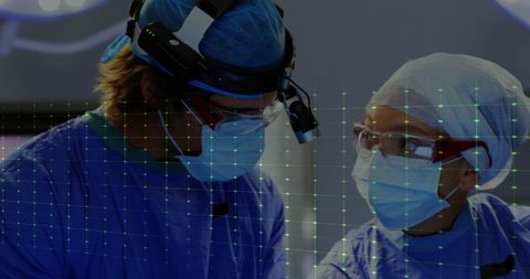 Surgeons using digital cardiograph technology in operating theatre
