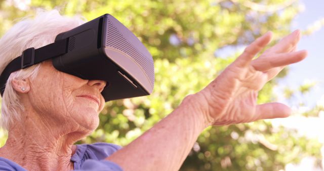 Senior Woman Exploring Virtual Reality Outdoors in Summer - Download Free Stock Images Pikwizard.com
