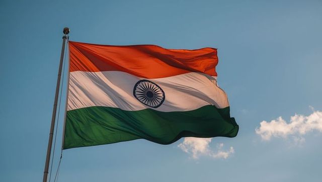 Indian national flag waving against blue sky and clouds