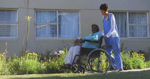 Compassionate Nurse Assisting Senior in Sunny Garden