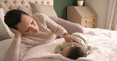 Mother Bonding with Baby Daughter on Bed in Cozy Home Environment
