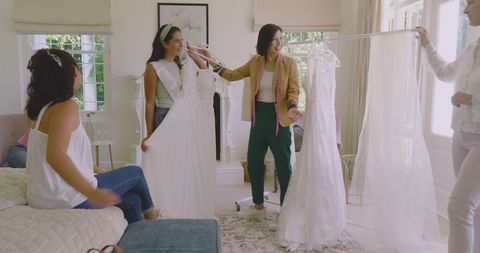 Bride-to-Be Choosing Wedding Dress with Friends in Cozy Room