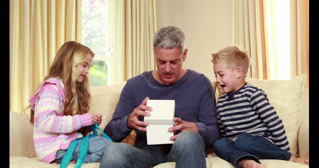 Father Receiving Gift from Children at Home - Download Free Stock Images Pikwizard.com