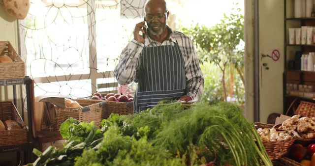 Senior male grocer managing store while talking on phone - Download Free Stock Images Pikwizard.com