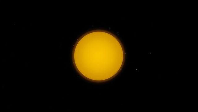 Bright solar disk in outer space with star points