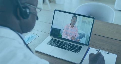 Senior doctor engaged in virtual consultation on laptop