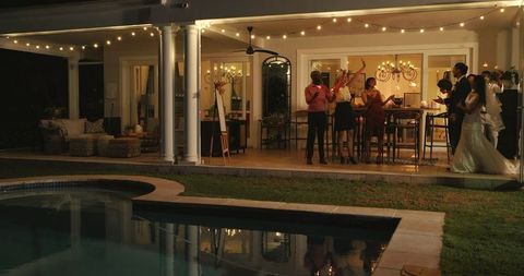 Elegant evening wedding celebration by pool