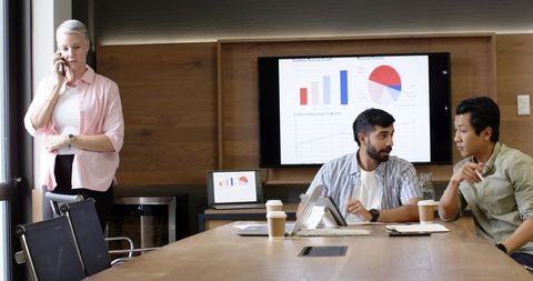 Diverse Office Team Engaging in Productive Meeting and Analysis