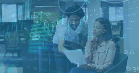 Coworkers Analyzing Report with Technological Overlay in Office Lounge