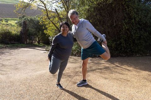 Active Senior Couple Stretching Outdoors on Sunny Day
