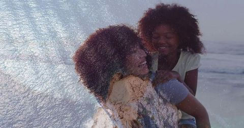 Smiling mother giving piggyback to daughter on beach double exposure with wave and rock texture