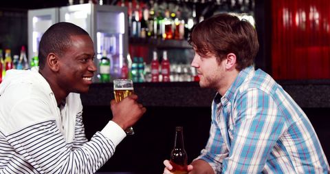 Two Friends Enjoying Drinks and Conversation at Bar - Download Free Stock Images Pikwizard.com