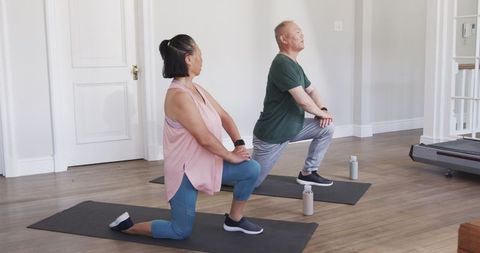Asian Seniors Enjoying Yoga and Wellness Routine at Home