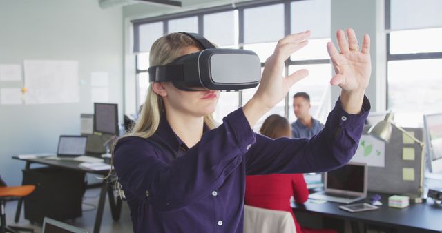 Casual Businesswoman Using VR Headset Interacting with Virtual Screen in Office - Download Free Stock Images Pikwizard.com