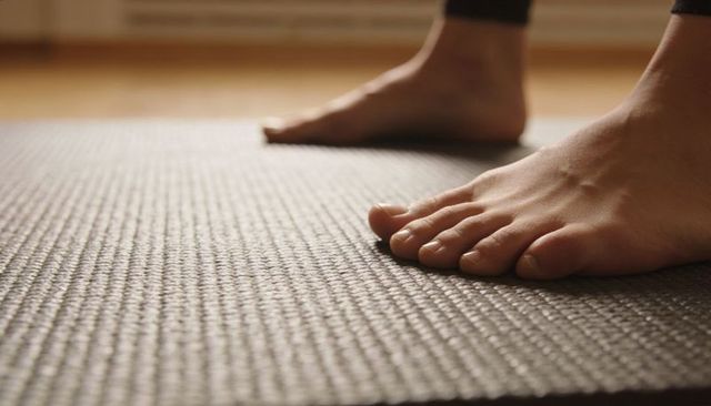 Bare feet grounding on textured yoga mat closeup for home yoga practice and mindfulness