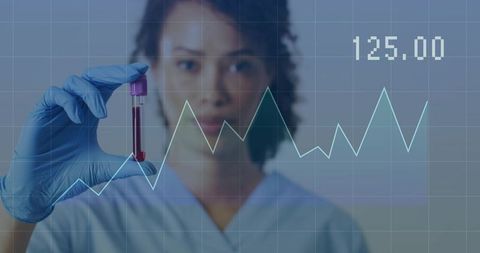 Laboratory technician holding blood sample with digital data chart overlay and analytics