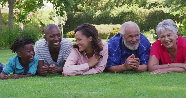 Smiling Multi-Generational Family Relaxing on Grass - Download Free Stock Images Pikwizard.com