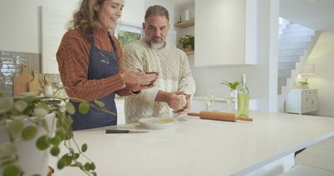 Couple Enjoying Baking Together in Bright Modern Kitchen