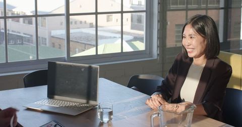 Businesswoman in Office Smiling During Meeting