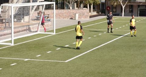 Soccer Players Defending Goal During Competitive Match