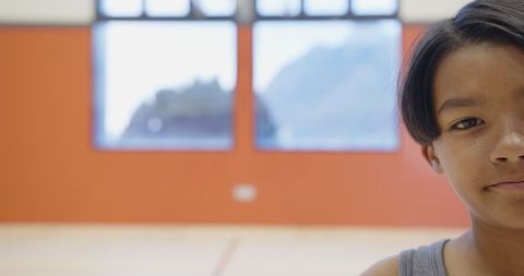 Boy Standing Confidently in School Gym Ready for Activities