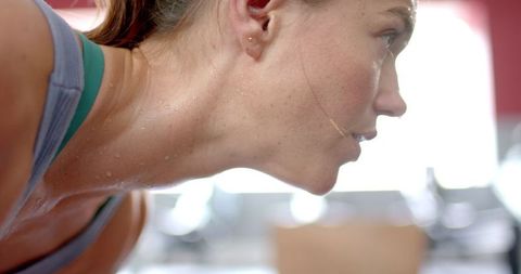 Close-Up of Athletically Driven Young Woman in Gym Setting