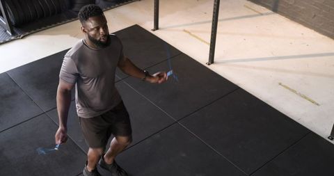 Man Jumping Rope in Minimalist Gym Setting for Cardio Training