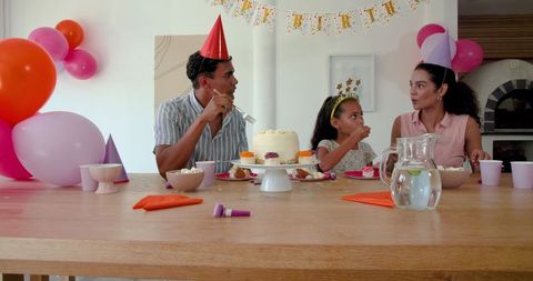 Family Celebrating Birthday with Party Evening at Home