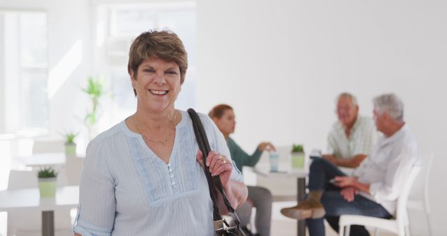 Senior Woman Smiling in Busy Social Room with Friends Near - Download Free Stock Images Pikwizard.com