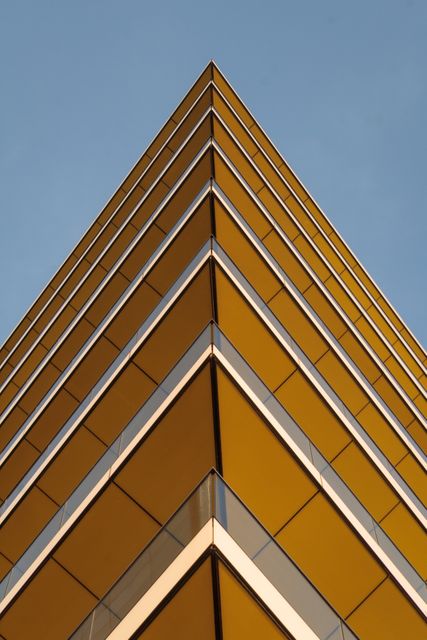 Geometric Low Angle View of Modern Building Against Blue Sky - Download Free Stock Photos Pikwizard.com