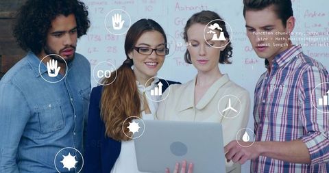 Diverse team collaborating on laptop with sustainable data visualizations in workspace