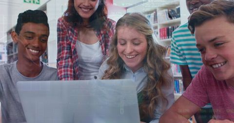 Diverse Students Collaborating on Laptop with Financial Charts