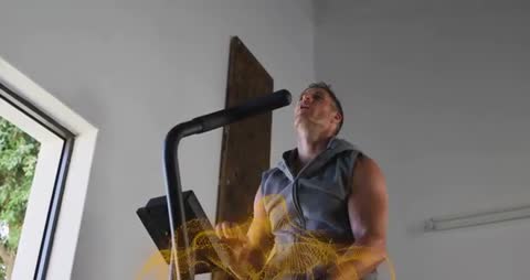 Man doing cardio on elliptical, pausing to breathe with dynamic golden motion trail