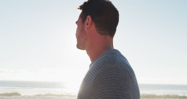 Man Enjoying Serene Beach with Sun Setting - Download Free Stock Images Pikwizard.com