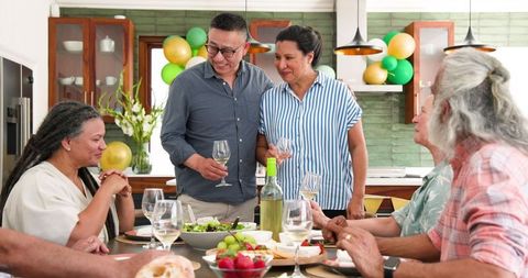 Senior Friends Enjoying Dinner Party and Toasting Together