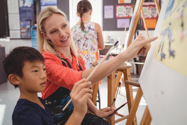 Teacher Assisting Schoolboy in Art Class - Download Free Stock Photos Pikwizard.com