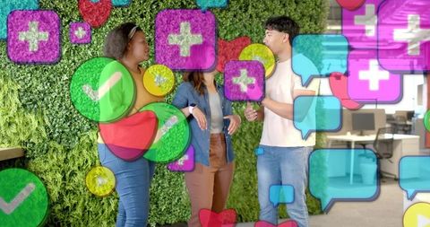 Diverse team collaborating in modern office lounge with living wall and social media icons