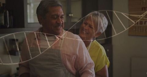 Senior couple embracing in kitchen with dna helix overlay symbolizing family health