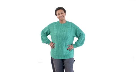 Smiling woman in green sweater exuding confidence