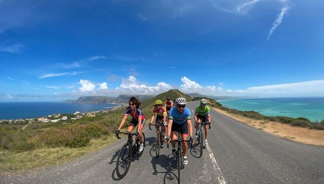 Cyclists Climbing Coastal Ridge Road Pedaling Toward Panoramic Ocean and Bay Views