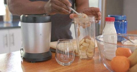 Preparing Nutritious Smoothie with Peanut Butter and Bananas