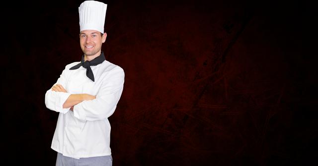 Portrait of confident chef standing with arms crossed against black background