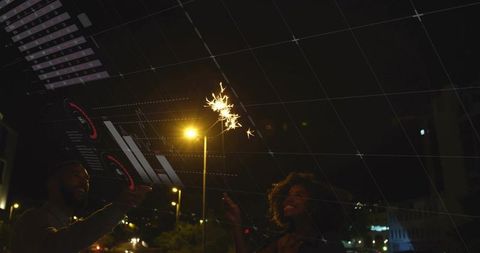 Couple holding sparkler under streetlamp with augmented reality hud overlay at night