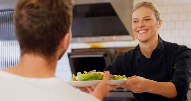 Smiling Restaurant Chef Serving Salad Dish to Customer - Download Free Stock Images Pikwizard.com